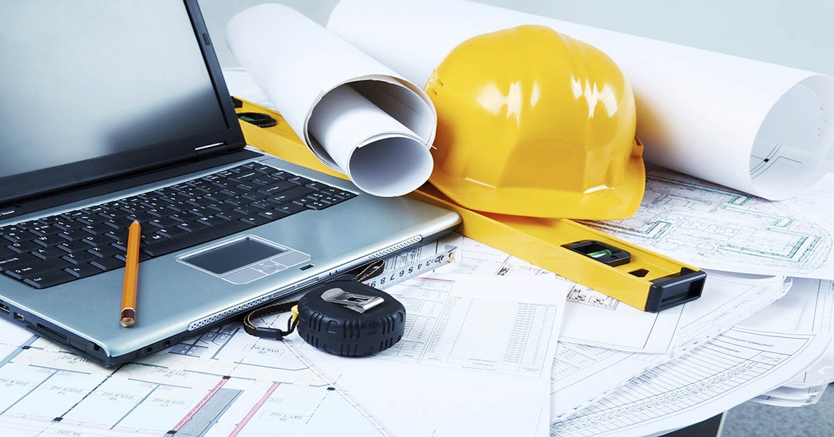 Image of laptop, architectural tools and blueprints